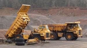 Off-Highway trucks parked in gravel pit.