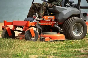 Lawn mower machine on a green lawn